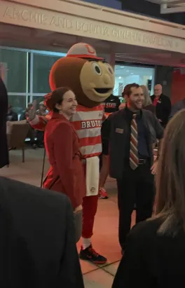 Maya and her husband posing with Brutus
